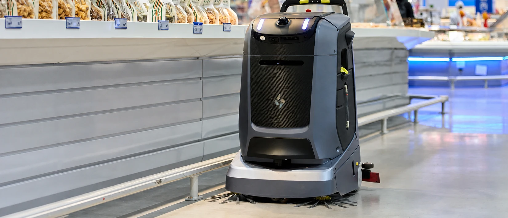 Gausium Mira cleaning robot in a supermarket aisle